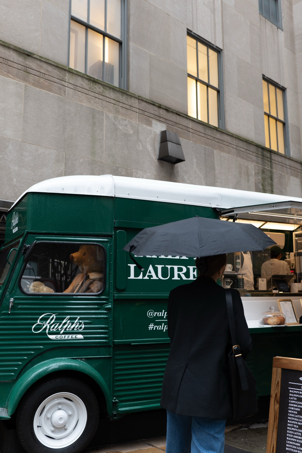 A green food truck and pedestrians in New York