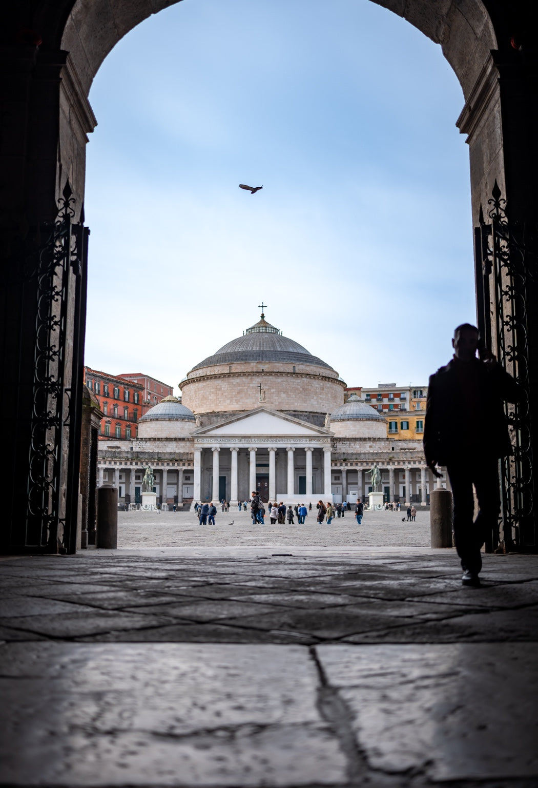 Piazza del Plebiscito framed by an arch in Naples