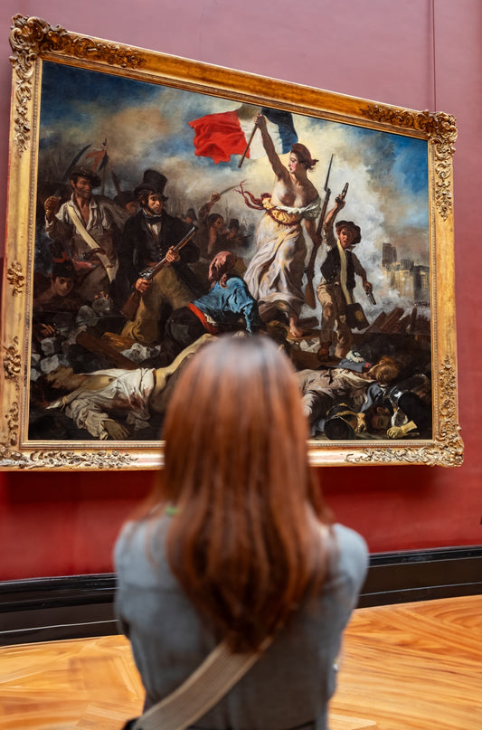 A visitor admiring Liberty Leading the People in Paris