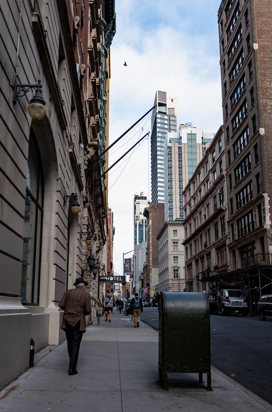 A lone pedestrian among New York buildings