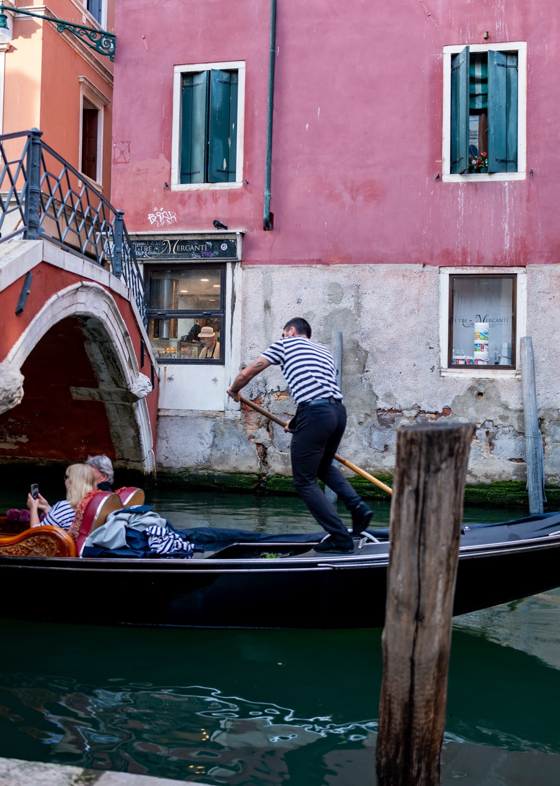 A pink facade beside a Venice canal