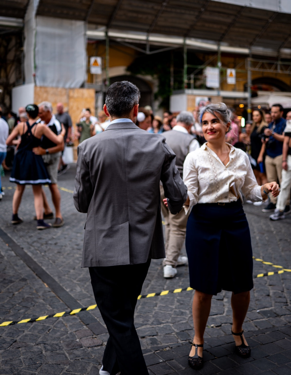 Two people dancing at an outdoor gathering