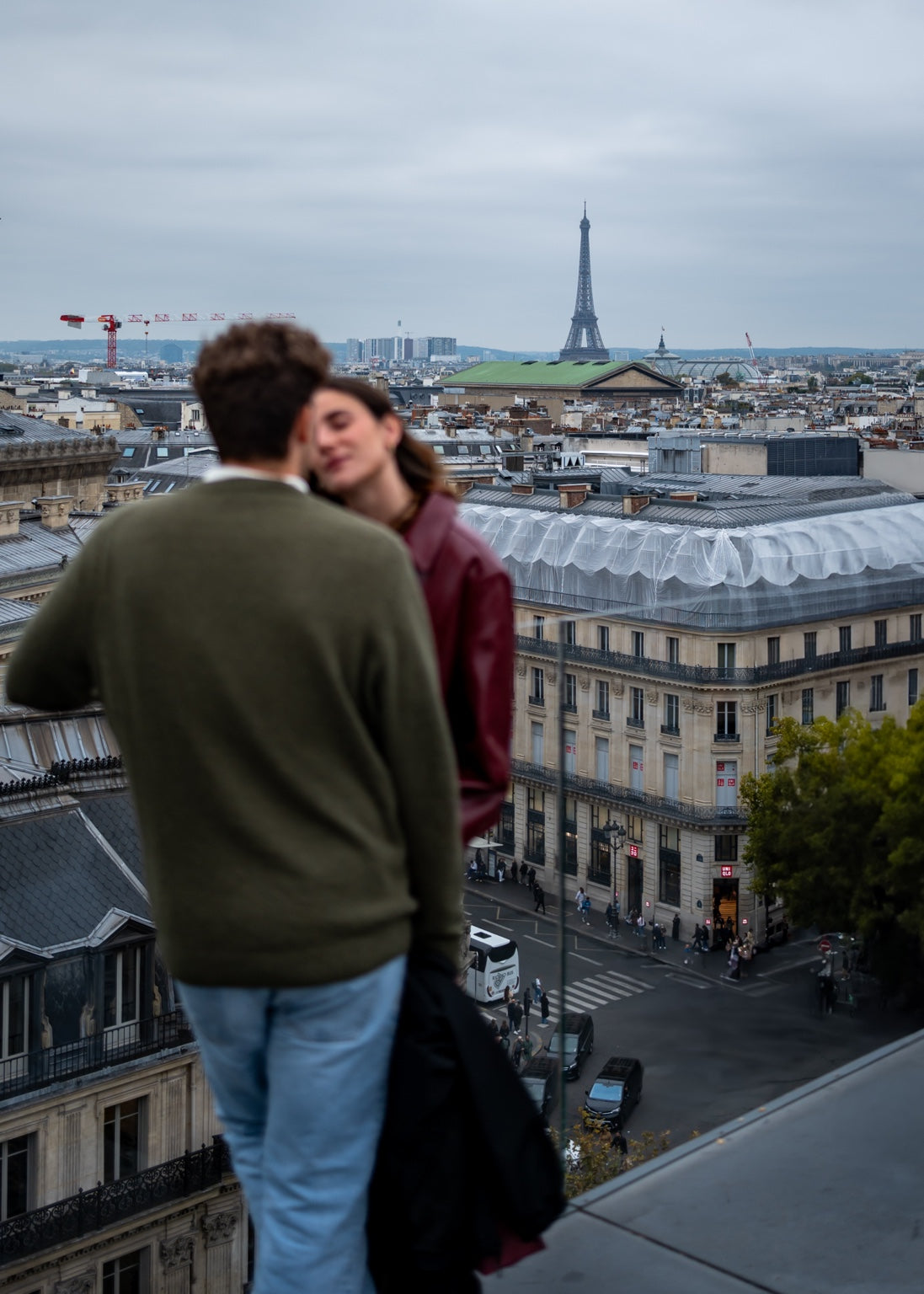 Couple overlooking Paris with the Eiffel Tower in the distance