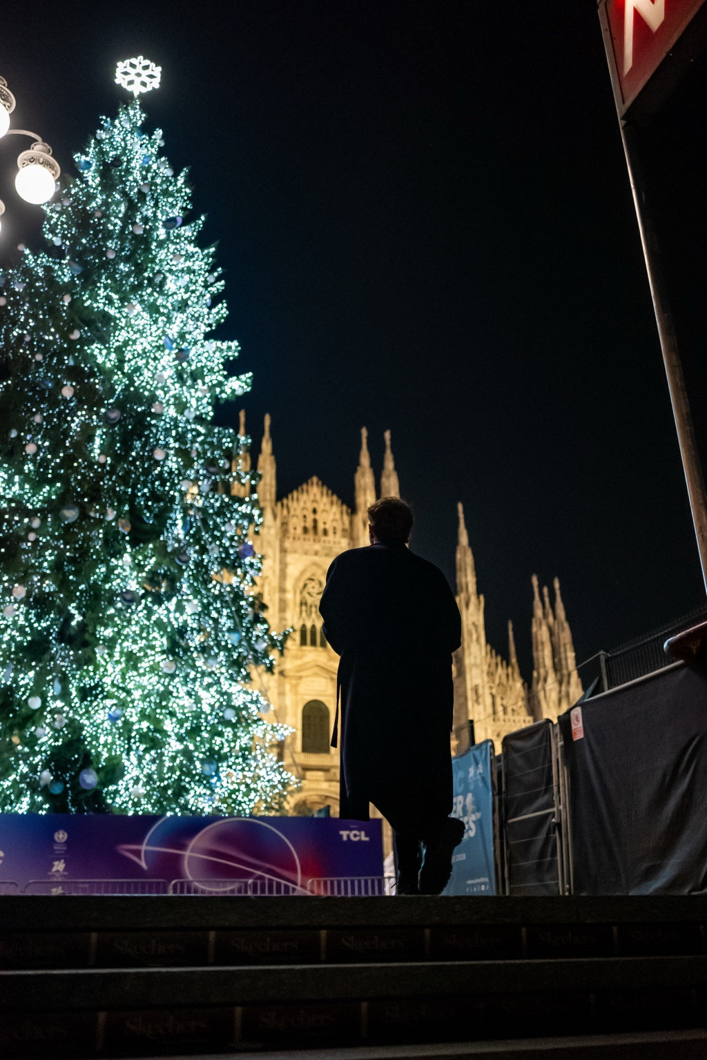 Illuminated Christmas tree in a city square at night
